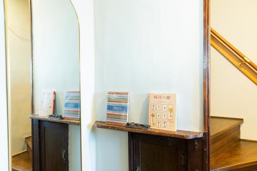 a mirror on a wall next to a staircase at HOTEL RIN TOKYO - Private Townhouse - in Tokyo