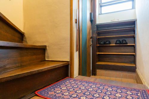 a walk in closet with a rug and an open door at HOTEL RIN TOKYO - Private Townhouse - in Tokyo