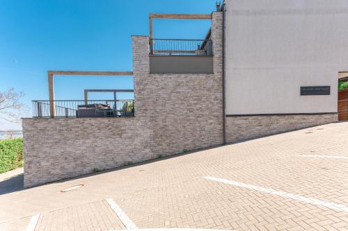 a brick building with two balconies on the side of it at Pálavské Apartmány Original in Pavlov