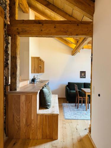 a kitchen and living room with a counter and a couch at GASSERHOF Dölsach in Dölsach