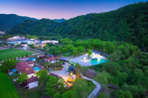 an aerial view of a resort with a swimming pool at Gapyeong Adelheim Pension Dogs Allowed, Group Rooms, Spa in Gapyeong