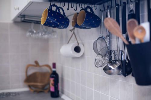 a kitchen with utensils hanging on a wall at ZenAmore in Genova