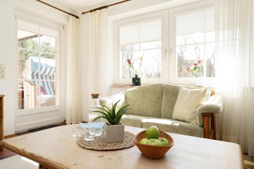 a living room with a couch and a table at Stephan in Petersdorf auf Fehmarn