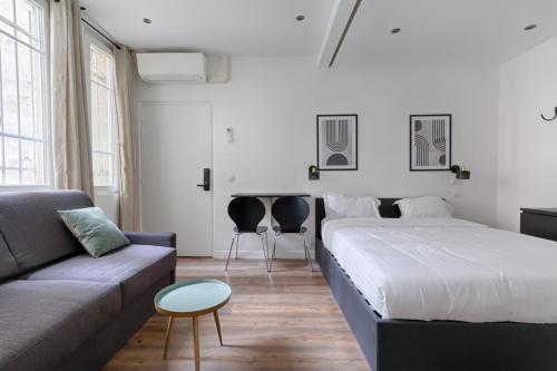 un salon avec un lit et un canapé dans l'établissement TBS 306 - Lovely studio in Paris, à Paris
