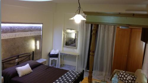 a bedroom with a bed and a mirror at Manganas Studios in Paleokastritsa