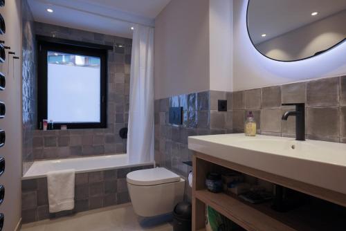 a bathroom with a sink and a tub and a toilet at Creatini Mountain in Zermatt