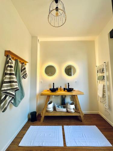 Cette chambre comprend une table et deux miroirs. dans l'établissement Villa Valentine terrasse vue Mer & Falaises, au Tréport