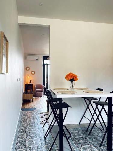 une salle à manger avec une table et des chaises blanches dans l'établissement Villa Valentine terrasse vue Mer & Falaises, au Tréport