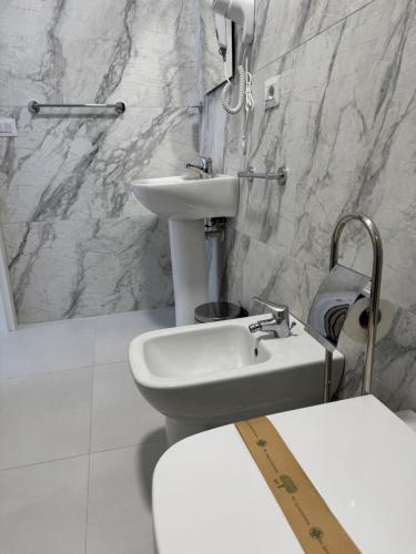 a bathroom with a sink and a toilet at A tre passi dal mare in Agropoli