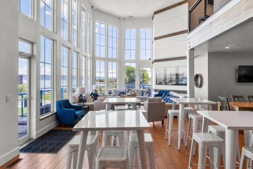 a large room with tables and chairs and windows at Sunrise Resort Room #301 in Garden City