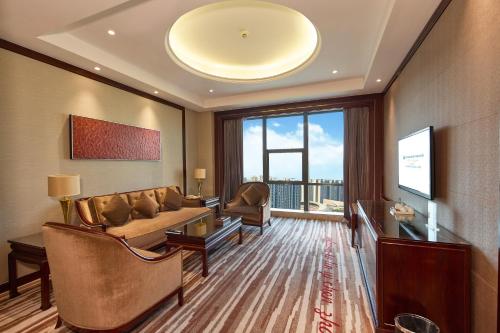 a living room with a couch and a table at Wyndham Grand Plaza Royale Chenzhou in Chenzhou
