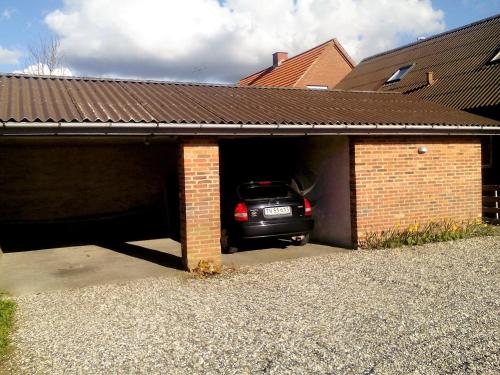 a car is parked inside of a garage at B&B Villa Filsø in Tim
