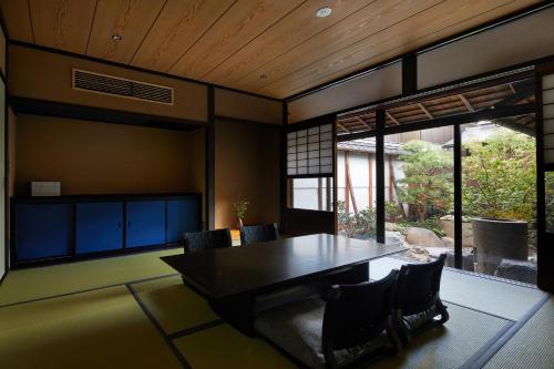 a dining room with a table and chairs at Enso Machiya in Kyoto