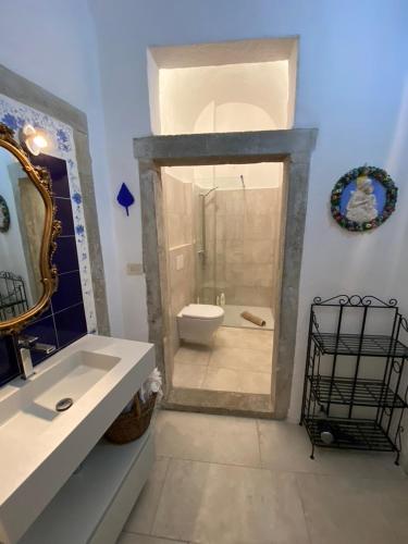 a bathroom with a shower and a sink and a toilet at La Piscina nel Borgo in Bagnone