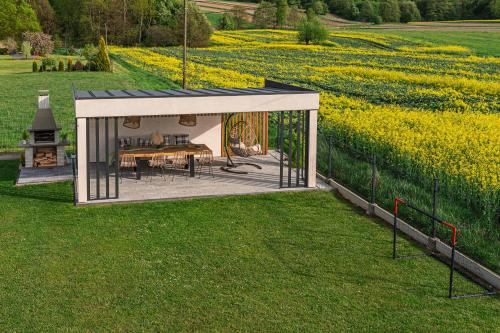 a pavilion with a playground in a field of flowers at Lamelove Apartments - Energylandia, Zator in Chocznia