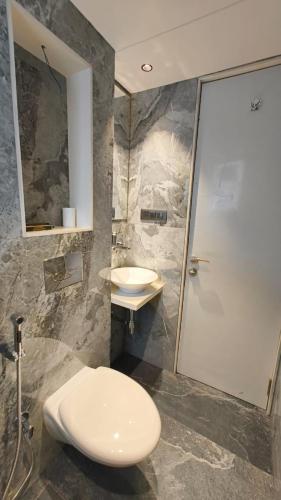 a bathroom with a toilet and a sink and a shower at Hotel Flexi Residency Mumbai International Airport in Mumbai