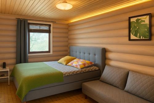 a small bedroom with a bed and a couch at Peaceful Wood-fired Sauna Stay in Vantaa