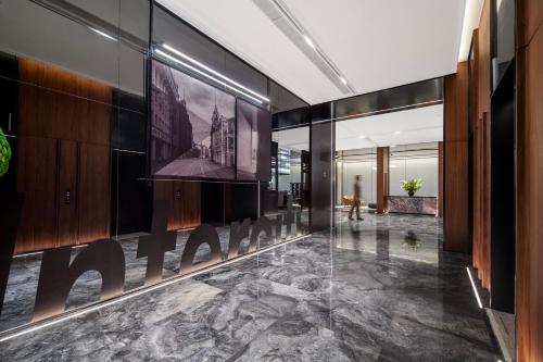a lobby with a sign on the wall of a building at Intercity Hotel Shanghai City Center - Free Mini Bar in Shanghai