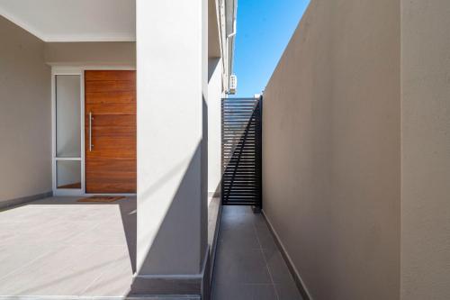 a staircase in a house with a wooden door at Tranquil Flatlet in Seapoint in Cape Town