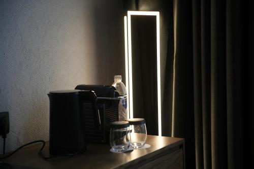 a table with a mirror and two glasses on it at The Local House Alaçatı in Alacati