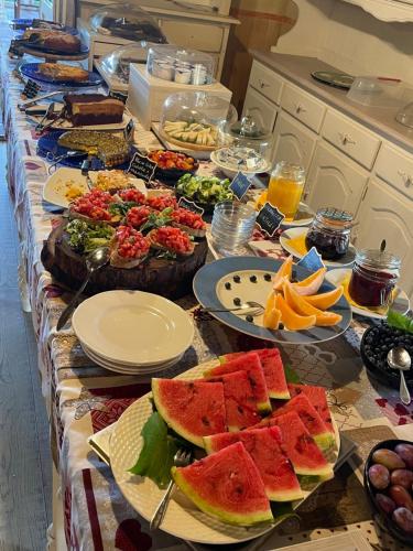 a long table with plates of food on it at Bio Agriturismo Il Melograno di Banditella Ristorante in Alberese