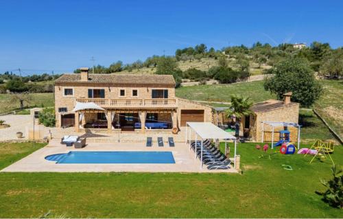 an aerial view of a house with a swimming pool at Villa Lorenzo Manacor by PriorityVillas in Manacor