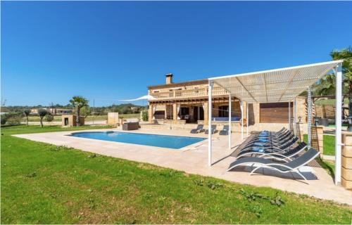 a group of lounge chairs next to a swimming pool at Villa Lorenzo Manacor by PriorityVillas in Manacor
