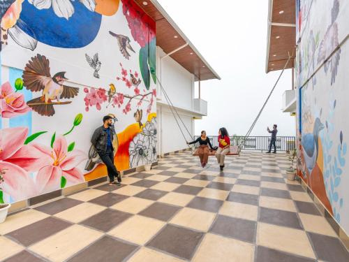 a mural on the side of a building with people walking down a hallway at The Hosteller Chakrata in Chakrāta