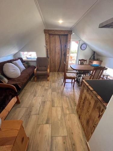 a living room with a couch and a table at Sioło Bobolin II in Bobolin