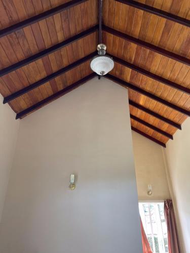 a room with a wooden ceiling and a light at The Vatican Villa in Nuwara Eliya