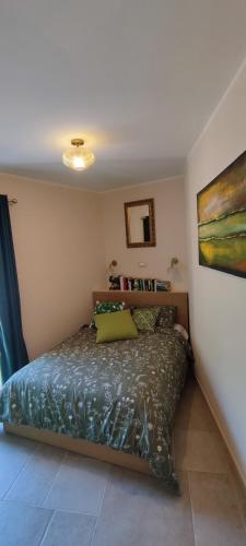 a bedroom with a bed and a painting on the wall at Casa Pablo in Badalucco