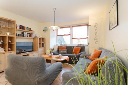 a living room with a couch and a table at Relax in Burg auf Fehmarn