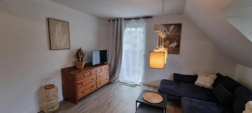 a living room with a couch and a tv at Moselhof in Burg