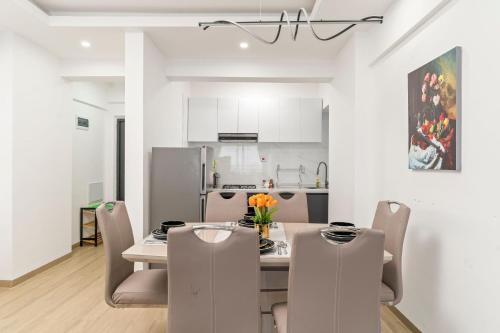 a kitchen and dining room with a table and chairs at 2 bedroom Marina Bay Square Apt Westland's Nairobi, Kenya in Nairobi