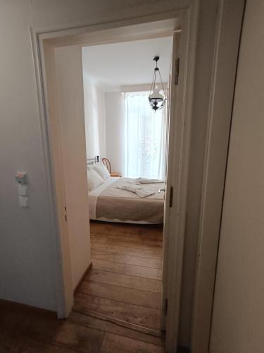 a white room with a bed and a window at Anesis Hotel in Loutra Edipsou
