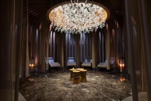 a large chandelier in a room with tables and chairs at Wyndham Grand Istanbul Levent Hotel & Conference Center in Istanbul