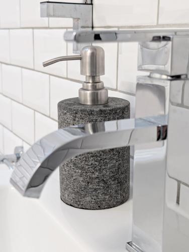 a bathroom sink with a chrome faucet at Eastgate Lodge Flat 23B in Pickering