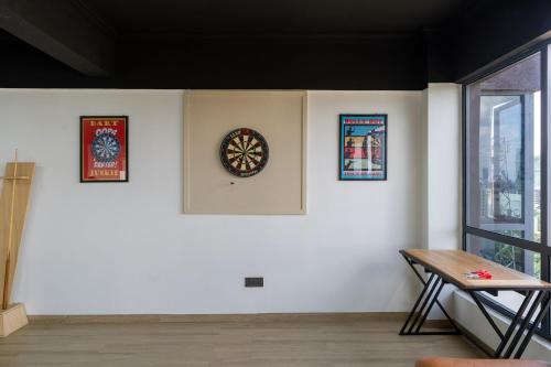 a white wall with a clock and pictures on it at 2 bedroom Marina Bay Square Apt Westland's Nairobi, Kenya in Nairobi