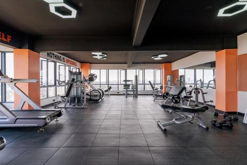 a gym with treadmills and elliptical machines at 2 bedroom Marina Bay Square Apt Westland's Nairobi, Kenya in Nairobi