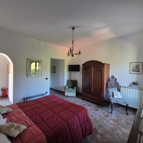 a bedroom with a large red bed and a chair at La Cicogna in Agerola