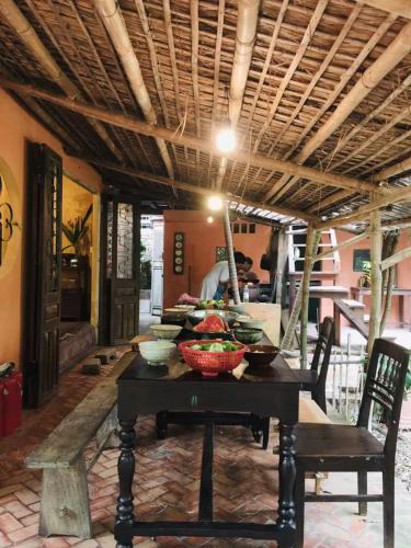 a dining room table with bowls of food on it at Yên homestay in Hoi An