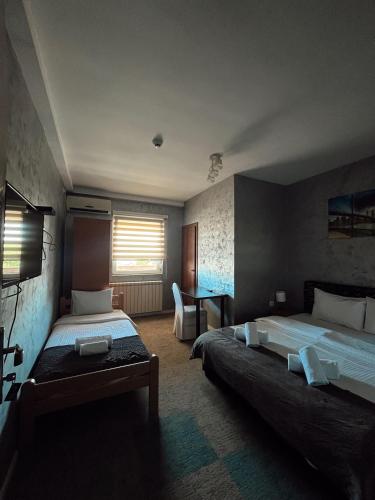 a hotel room with two beds and a window at Kengur Resort in Belgrade