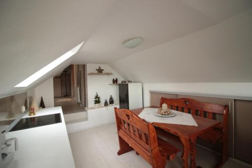 a kitchen with a dining room table and a refrigerator at Mini Vacanta La Munte in Zărneşti