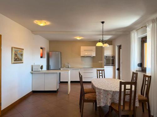 a kitchen and dining room with a table and chairs at Casa Sol Maris in Novigrad Istria