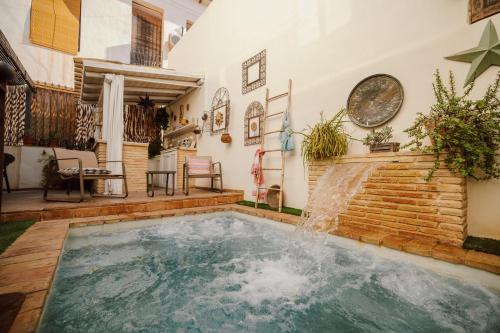 a swimming pool with a waterfall in a house at La Casa de los Coy in Mula
