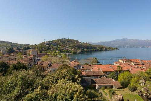 a town on a hill next to a body of water at appartamenti i fiori del lago in Laveno