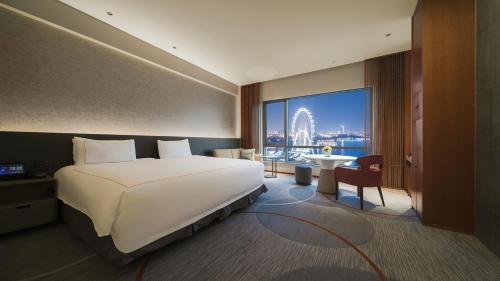 a bedroom with a large bed and a large window at InterContinental Suzhou Hotel by IHG in Suzhou