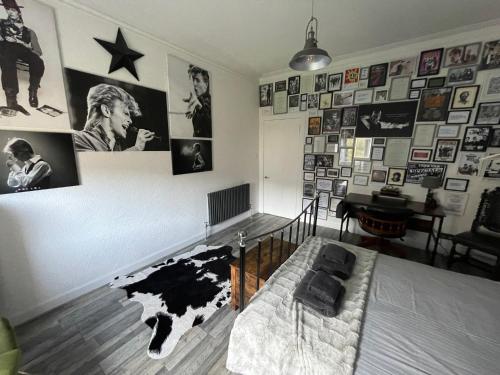 a room with a bed and pictures on the wall at Isle of Bute Blissful Retreat- Stunning 3 Bed Flat in Rothesay