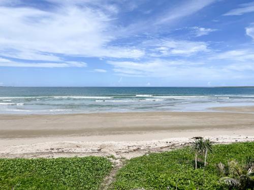 a beach with the ocean on a cloudy day at Baia Nest LANAI Glamping in Open Space within Self-Service Villa Near the Beach, Pet Friendly with a Fee in Gubat