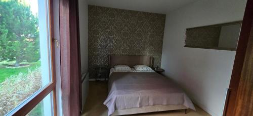 a small bed in a room with a window at Apartament Mestwina 54 Jurata in Jurata